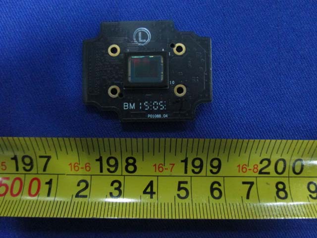 Compact image sensor module on black PCB.
