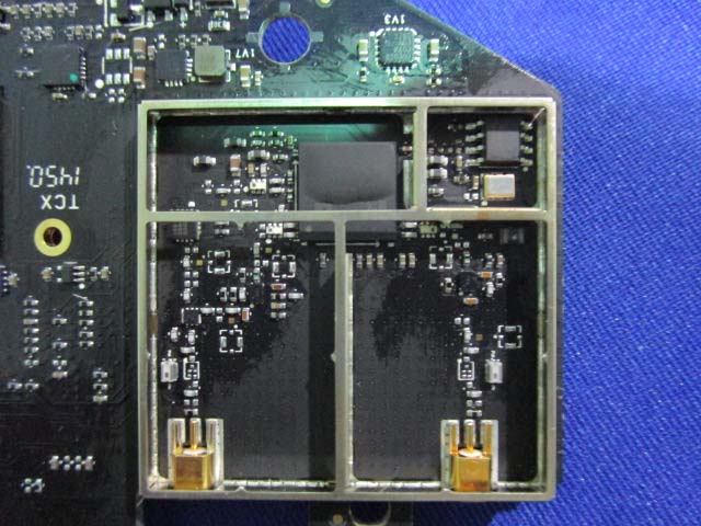 RF section with U.FL connectors and EMI shielding cans.