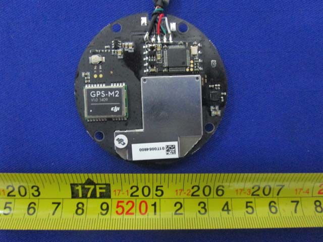 Circular PCB featuring GPS-M2 module and protective shielding.