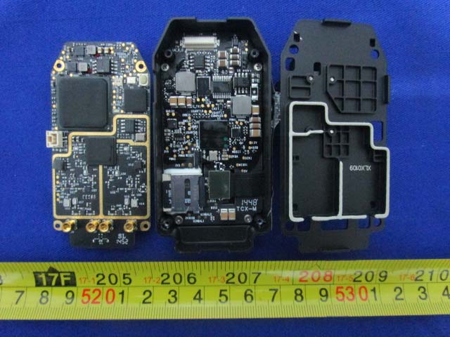 Main PCB featuring SoC, memory ICs, and EMI shielding.