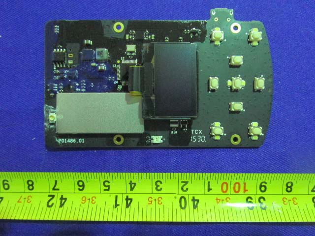 PCB with multiple buttons and metal shield over RF components.