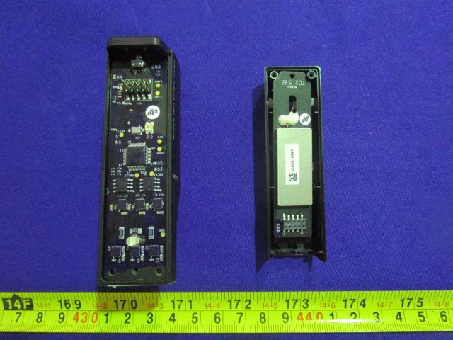 PCB with central microcontroller, antenna component, and power regulation circuitry.