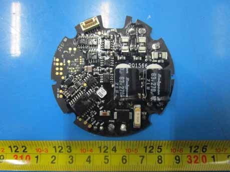 Circular PCB with large capacitors for power filtering and modular connector.
