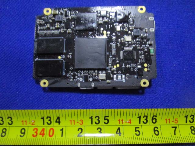 Main flight controller PCB with BGA processor and memory chips.