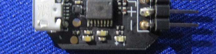 Main PCB with micro-USB, IC, and 2-pin header for interfacing.
