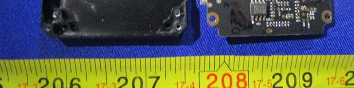 Partial PCB view with QFN IC, fine-pitch traces, and enclosure.