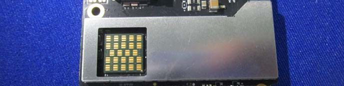 BGA footprint beneath shield can, dense passives, and ground stitching.