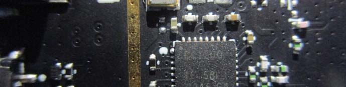 Close-up of main IC with RF trace and crystal oscillator.
