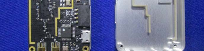 PCB with central SoC and machined metal RF shield/antenna.