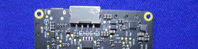 PCB section with shielded RF connector and power regulation.