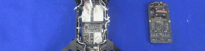 Drone chassis with internal PCB, coaxial cables, and modular board assembly.