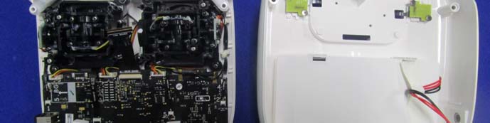Controller housing with dense PCB, joystick assemblies, and robust RF/power connectors.