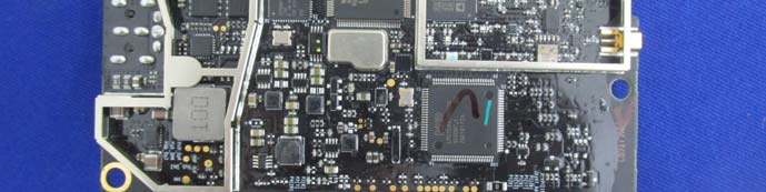 High-density main PCB with RF shielding and external antenna connector.