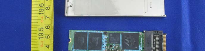 Exposed M.2 SSD PCB with NAND flash and controller ICs.