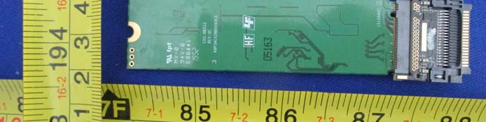 Backside of SSD PCB showing edge connector and test points.