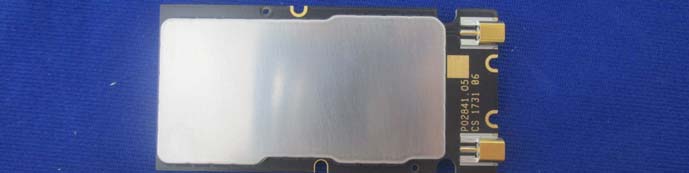 Large EMI shield with dual gold RF connectors for external antenna integration.