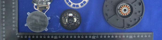 Disassembled radar: circular PCB, stator, and encoder for rotation feedback.