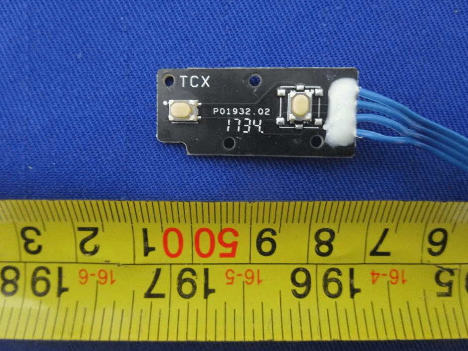 User interface board with tactile switches and strain-relief wiring.