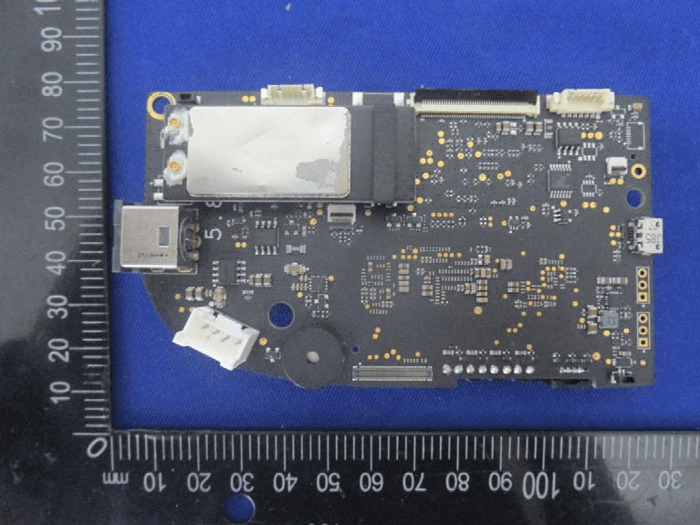 Populated PCB with EMI shield, connectors, and high-density component layout.