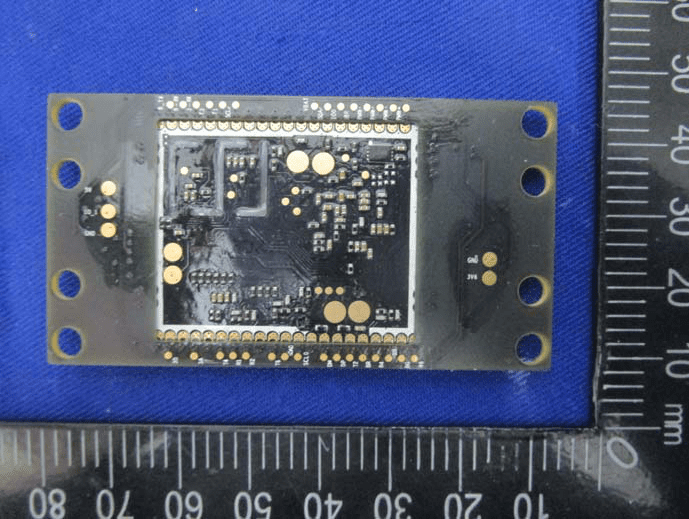 Internal module PCB underside with BGA pad array and extensive ground vias.
