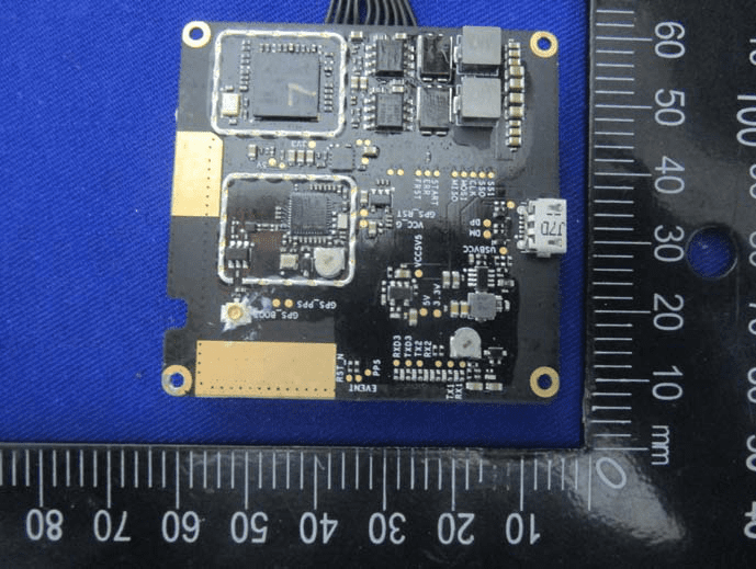 Main PCB with shielded GNSS/RTK ICs, power management, and antenna interfaces.
