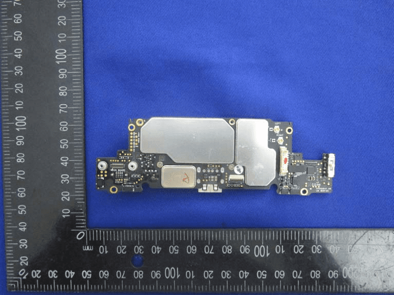 Main flight controller PCB with shielded SoC and RF blocks, high-density layout.
