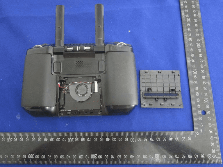 Rear cover removed, showing cooling fan, modular connectors, and external antenna mounts.