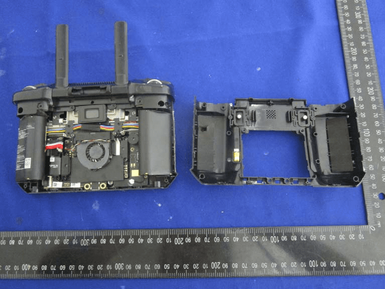 Main PCB with batteries, shielding, and dual external antennas exposed.