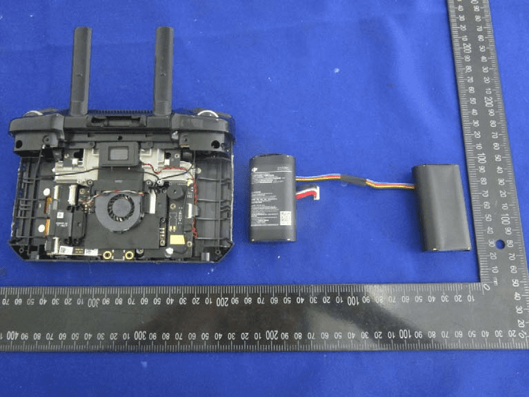 Densely populated PCB with active cooling, modular battery, and dual antennas.