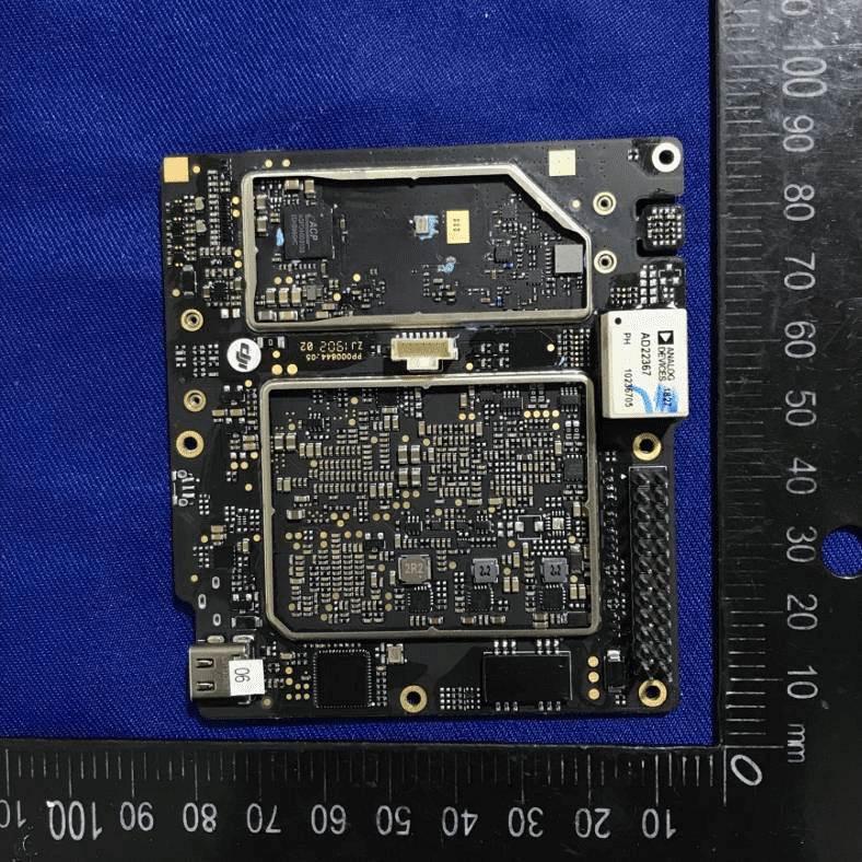 Flight controller PCB with shielded analog/RF sections and high-density components.