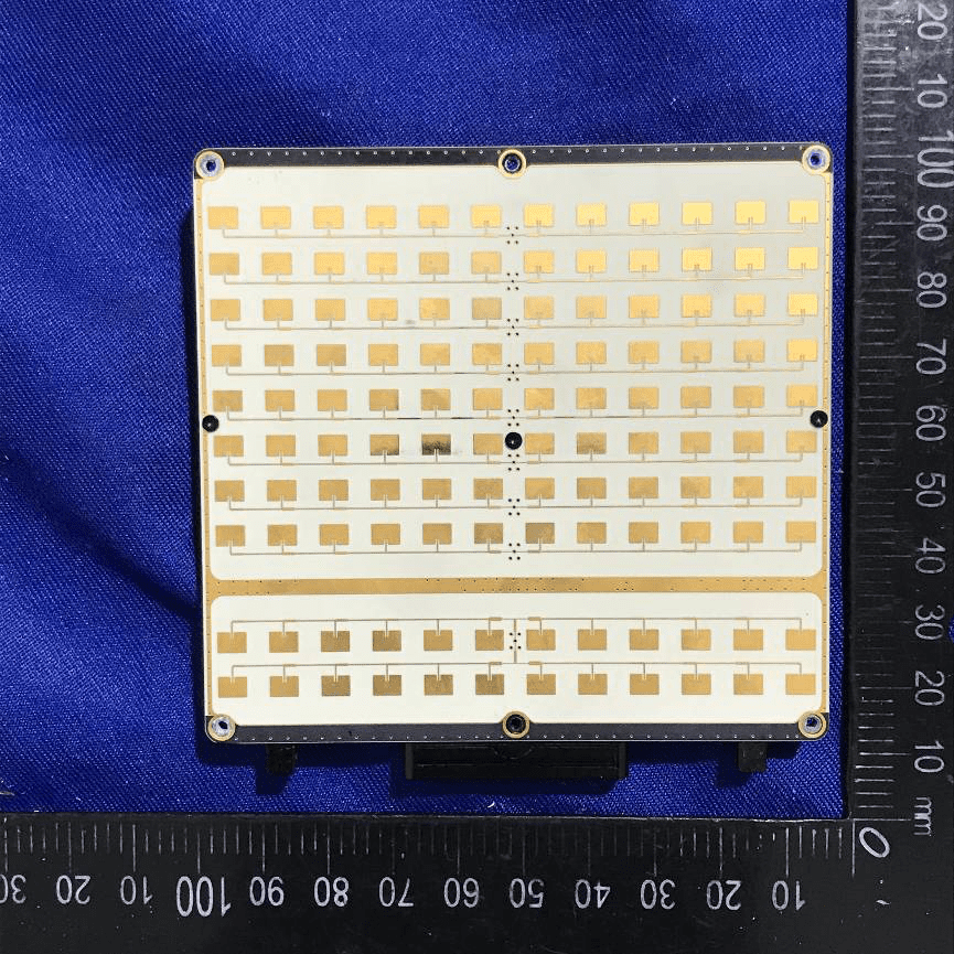 White PCB with microstrip phased array antenna elements.