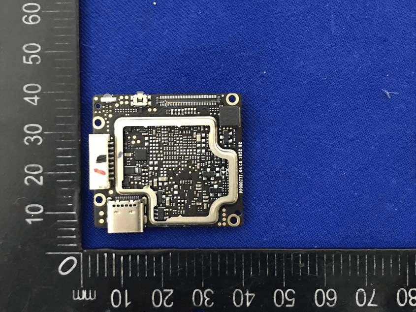 Dense PCB with RF shield and U.FL antenna connector.