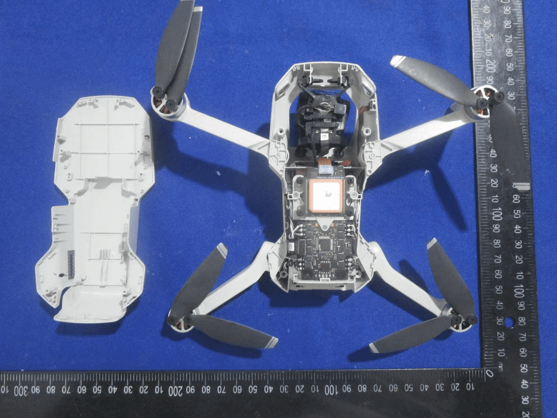 Main PCB with SoC, GPS antenna, and gimbal linkages exposed.