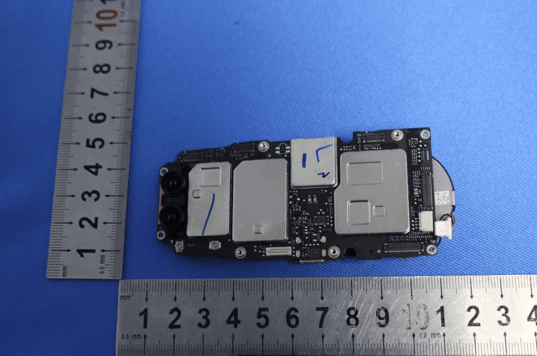Main logic board with shielded SoCs, stereo camera modules, and dense component integration.