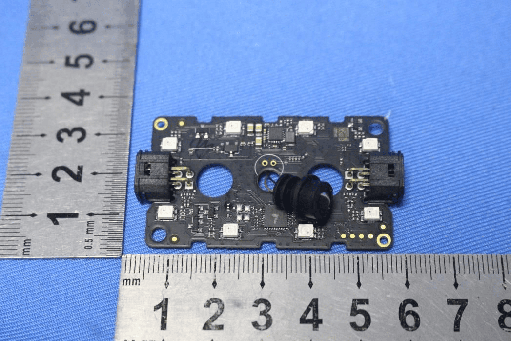 Compact vision/sensor module with central optical sensor and dual connectors.