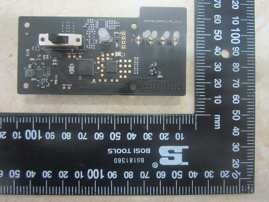 Compact PCB with microcontroller and system interface connectors.