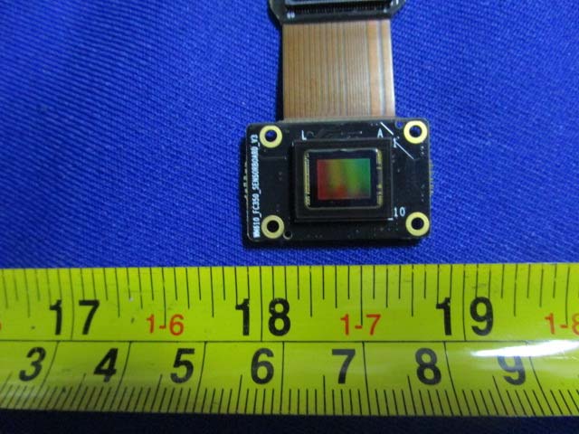 CMOS camera sensor module connected via flexible flat cable.