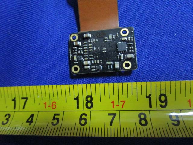 Small PCB with central IC and flexible cable connector.
