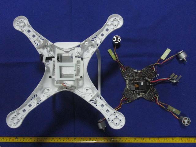 Flight controller PCB with attached motor connectors and power circuitry.