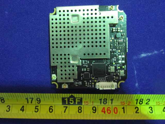 Communications/flight controller PCB with large EMI shield and modular connector.