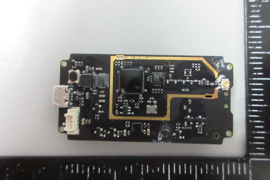 Main controller IC, RF trace, and power management components on dense PCB.