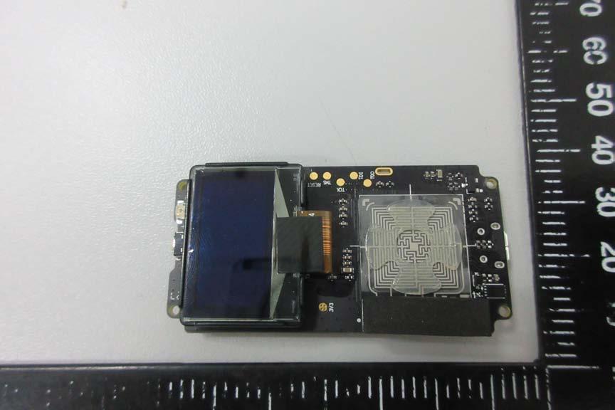 OLED display and PCB antenna integrated on high-density black PCB.