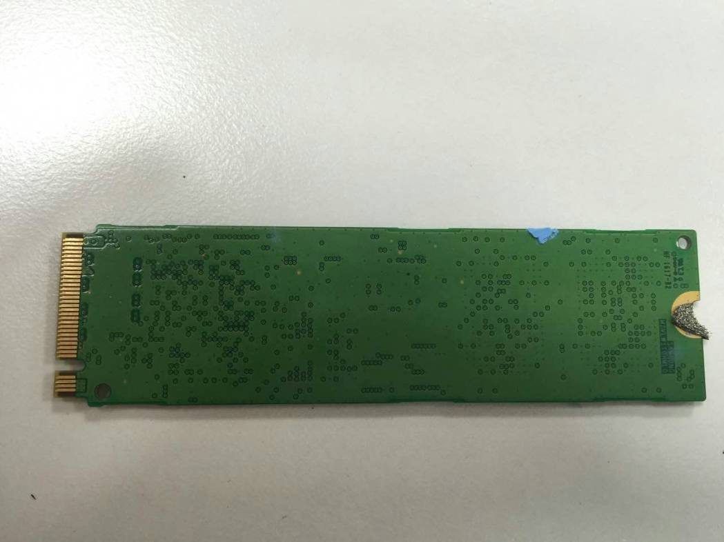 PCB underside showing dense vias and M.2 edge connector.