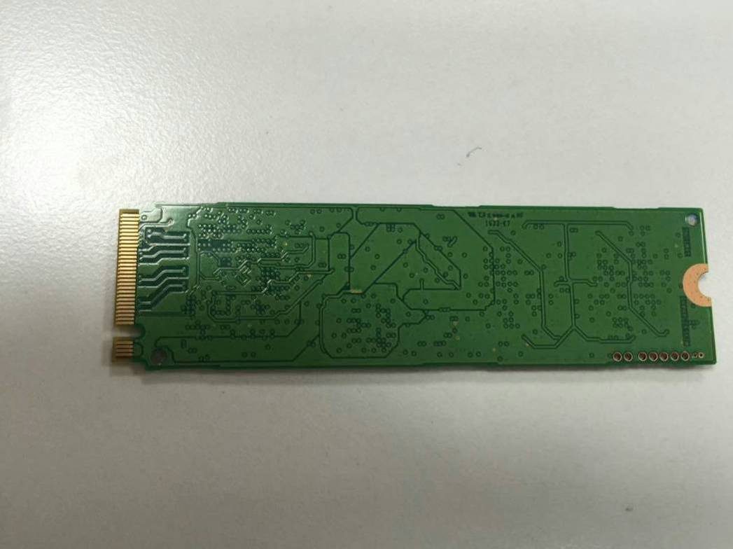 Bare underside of M.2 SSD PCB with gold-finger connector.