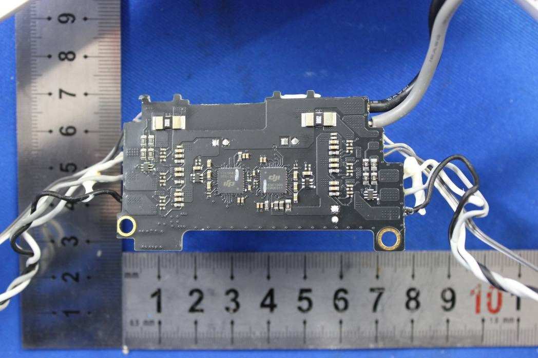 PCB with DJI-branded ICs and multiple wire harnesses.