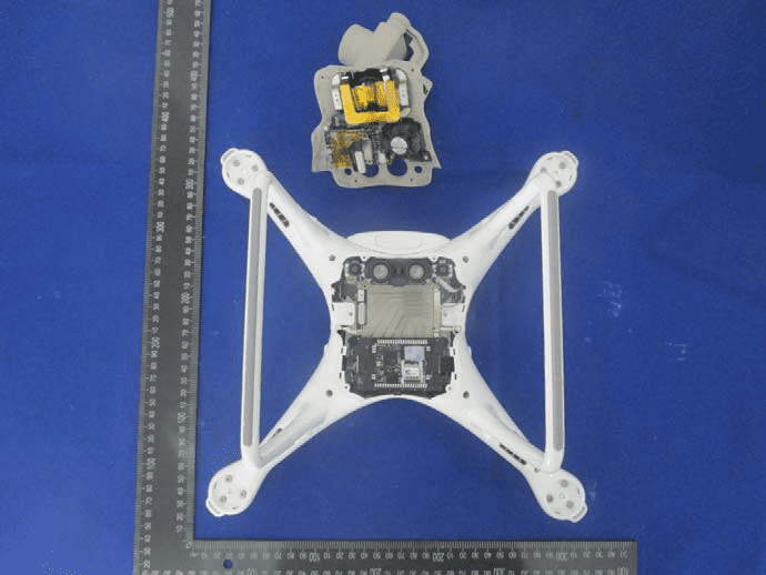 Main chassis open, showing central PCB with heatsink and modular power/gimbal assembly.