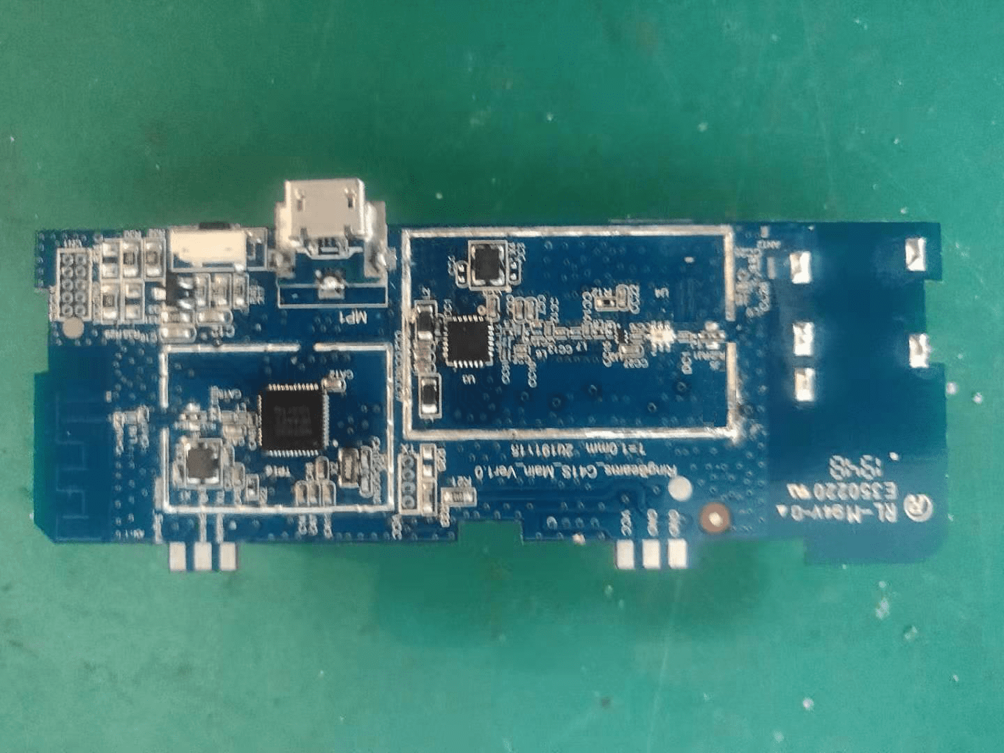 Wireless controller PCB with integrated antenna and micro-USB charging port.