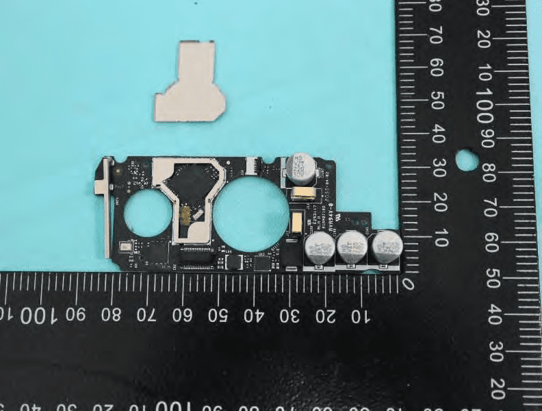 Exposed SoC, memory, and robust power filtering after shield removal.