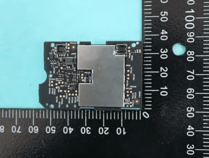 Mainboard with central shield, FPC connectors, and test points for diagnostics.