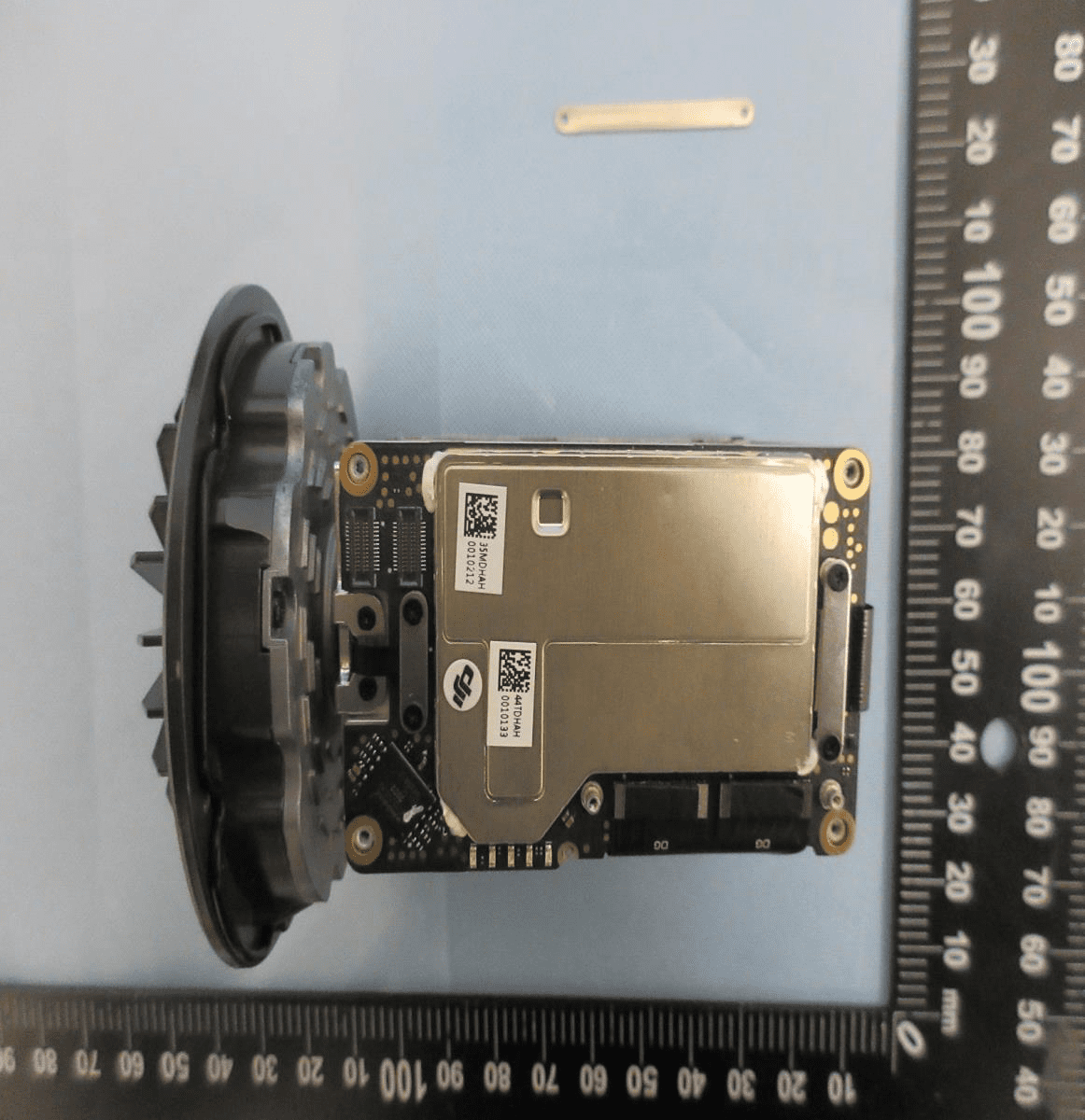 Main PCB with extensive EMI shielding, connectors, and thermal management features.